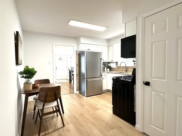 a kitchen with stainless steel appliances kitchen island a refrigerator and a stove top oven