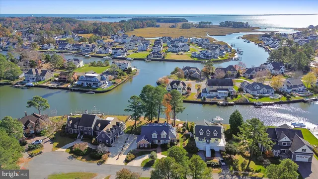 an aerial view of residential houses with outdoor space and swimming pool