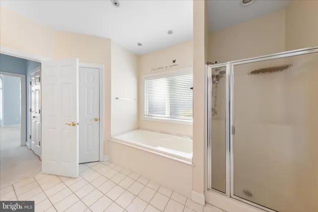 an empty room with windows and ceiling fan