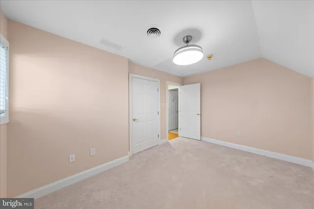 a bathroom with a granite countertop sink a toilet and a mirror