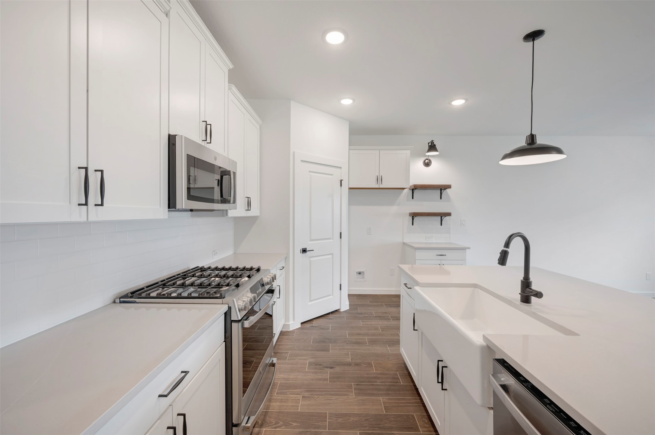 7918 Jasper Mdws Way Angleton, TX 77515 - Photo 6 of 31 Stylish kitchen with quartz counters and floating shelves