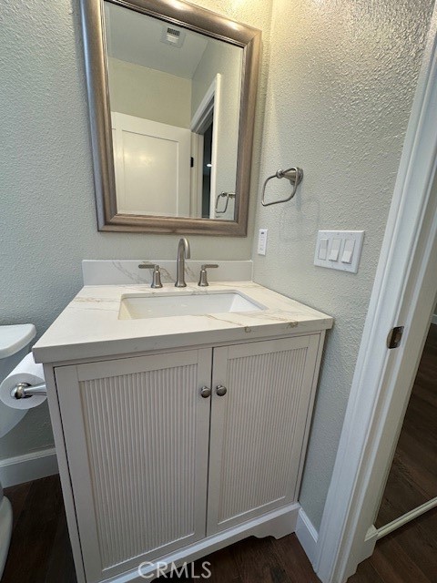 44649 La Paz Road, Unit F Temecula, CA 92592 - Photo 18 of 23 a bathroom with a sink vanity and a mirror