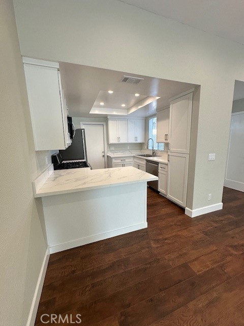 44649 La Paz Road, Unit F Temecula, CA 92592 - Photo 6 of 23 a view of kitchen with kitchen island microwave and wooden floor