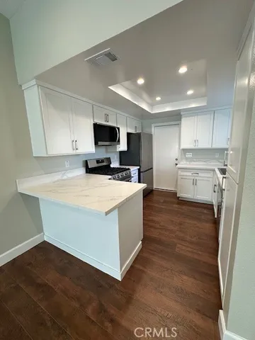 a kitchen with sink and cabinets