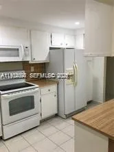 a kitchen with cabinets appliances and a sink