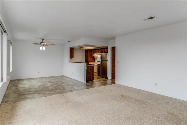 a room with pool table and windows