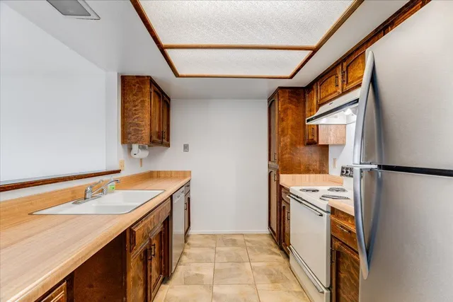 a kitchen with a sink stove and refrigerator