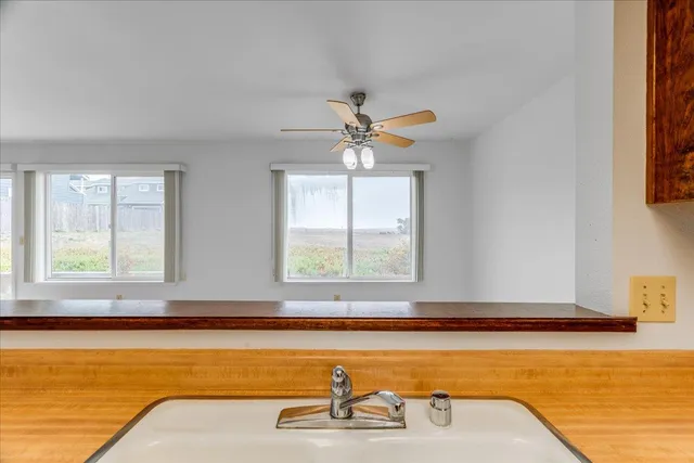 a view of a kitchen with a sink and a refrigerator