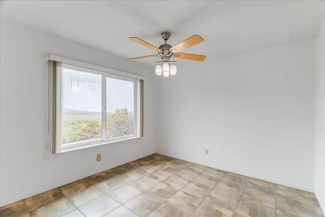 a view of an livingroom with a window and a kitchen
