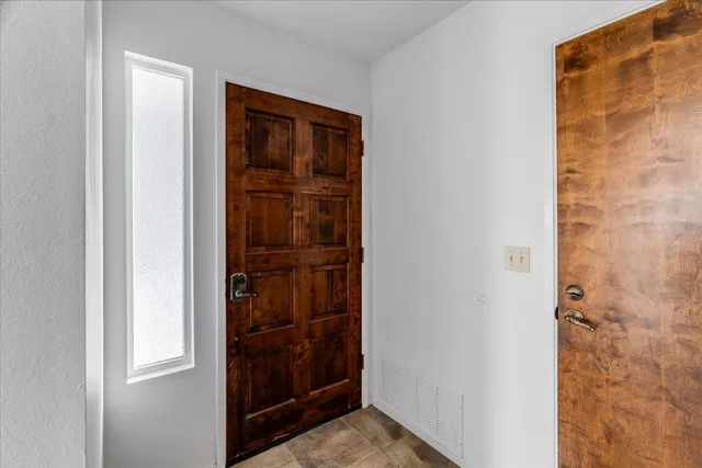 a view of an empty room with a fireplace and a floor to ceiling window
