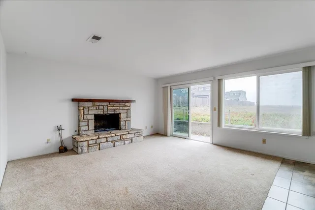 a view of an empty room with a fireplace
