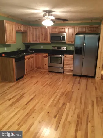 a kitchen with stainless steel appliances granite countertop a sink and a microwave