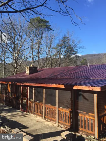 a view of a brick house with large windows