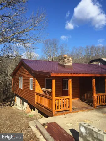 a view of a house with wooden fence