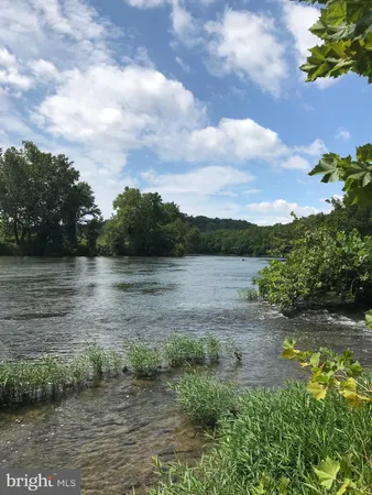 a view of a lake with houses in the back