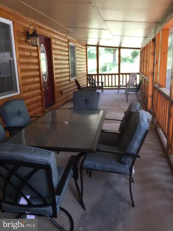 a view of a dining room with furniture and window