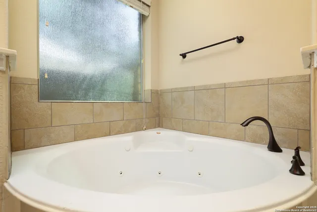 a bathroom with a white bath tub and shower