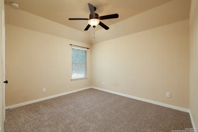 a view of room with a ceiling fan and window