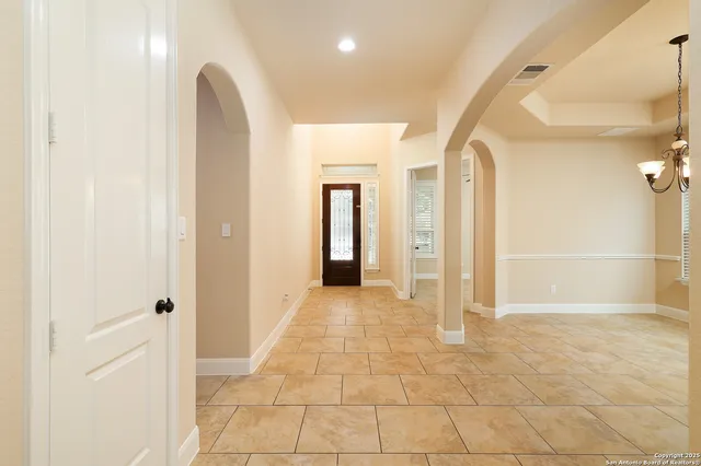 a view of a hallway with wooden shelves
