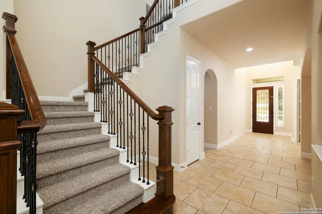 a view of entryway with wooden floor and stairs