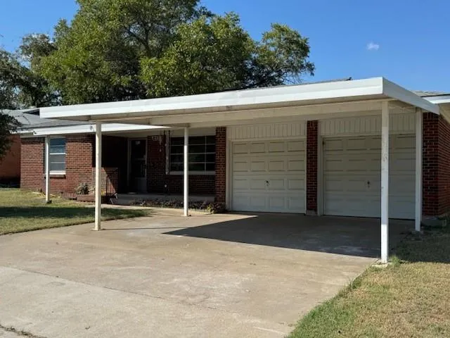 a backyard of a house with garden and garage