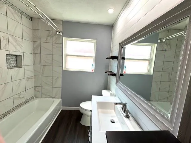 a bathroom with a sink a bathtub and next to a window