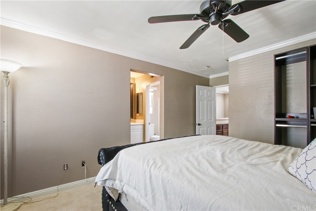 10 Alevera Irvine, CA 92618 - Photo 17 of 22 a bedroom with a bed and a chandelier