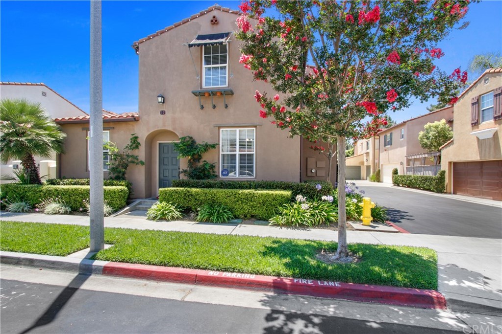 10 Alevera Irvine, CA 92618 - Photo 2 of 22 a front view of a house with a yard and table and chairs