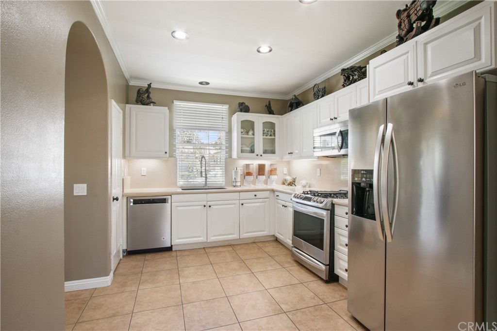 10 Alevera Irvine, CA 92618 - Photo 6 of 22 a kitchen with granite countertop stainless steel appliances cabinets and a sink
