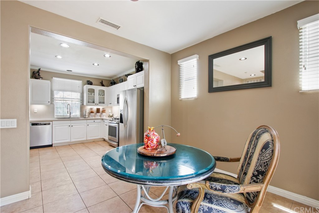 10 Alevera Irvine, CA 92618 - Photo 8 of 22 a kitchen with stainless steel appliances a dining table and chair