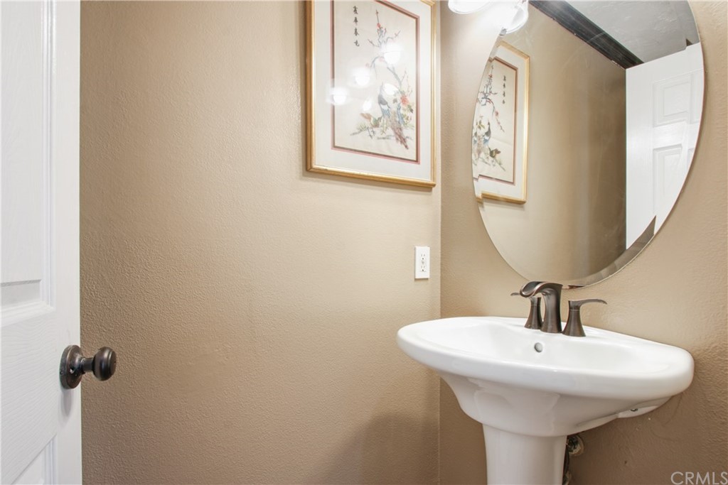 10 Alevera Irvine, CA 92618 - Photo 10 of 22 a bathroom with a sink and mirror
