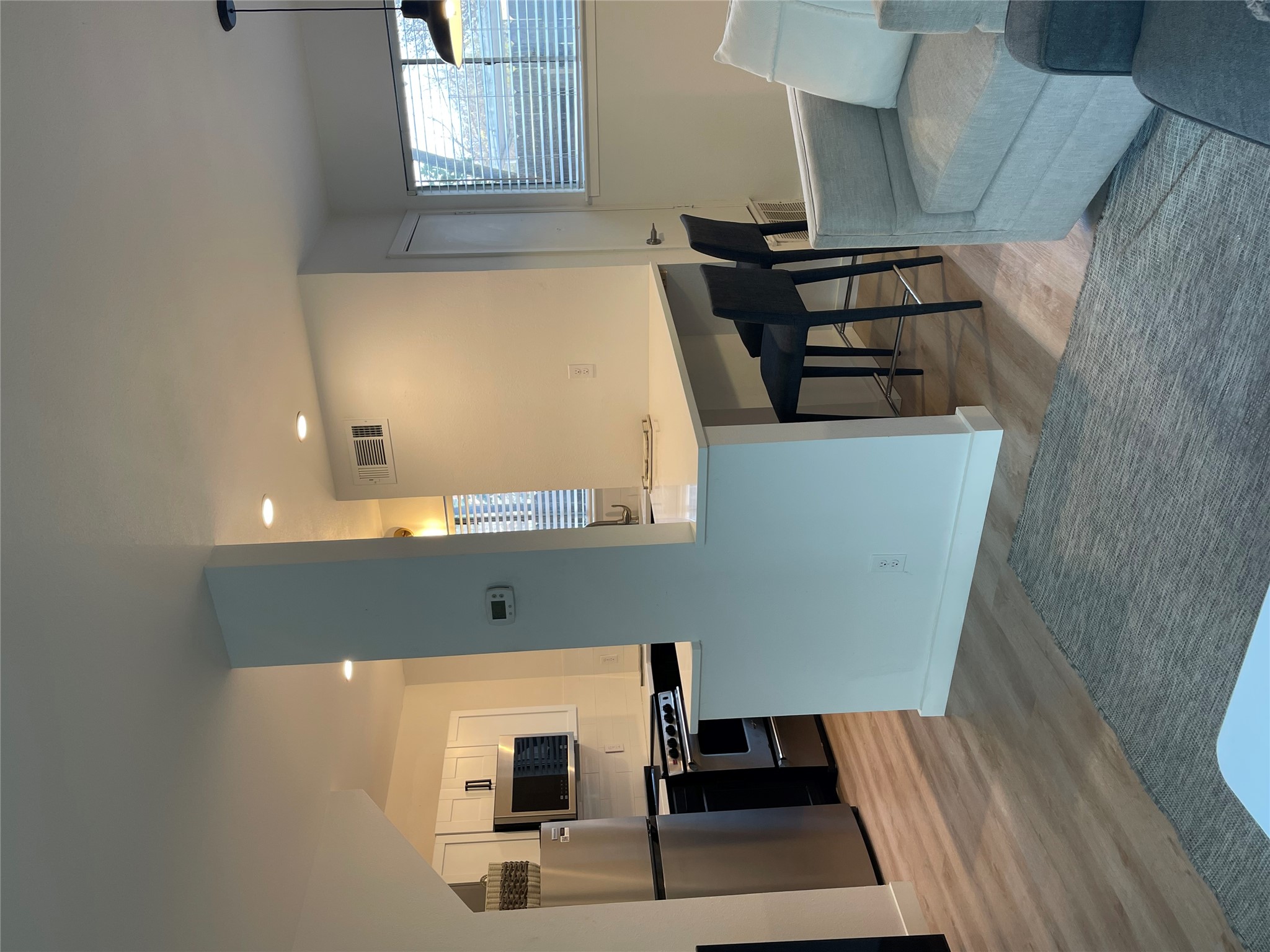 1714 Enfield Road, Unit 102 Austin, TX 78703 - Photo 3 of 15 A well-appointed kitchen features stainless steel appliances and an inviting breakfast bar.
