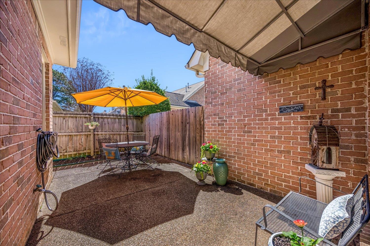1727 Village Ridge Road Collierville, TN 38017 - Photo 27 of 33 a view of a patio with a table and chairs under an umbrella