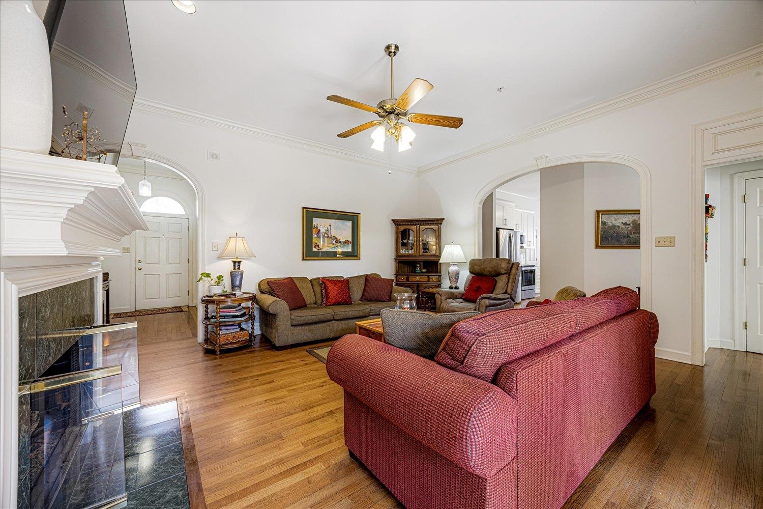 1727 Village Ridge Road Collierville, TN 38017 - Photo 7 of 33 a living room with furniture a fireplace and a ceiling fan