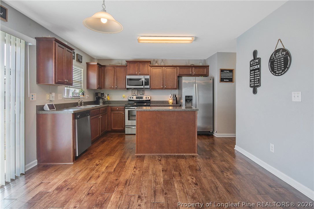 340 Battery Way Bunnlevel, NC 28323 - Photo 9 of 50 a kitchen with stainless steel appliances granite countertop a stove top oven a sink a counter space and cabinets
