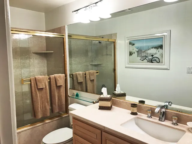 a bathroom with a sink mirror and toilet