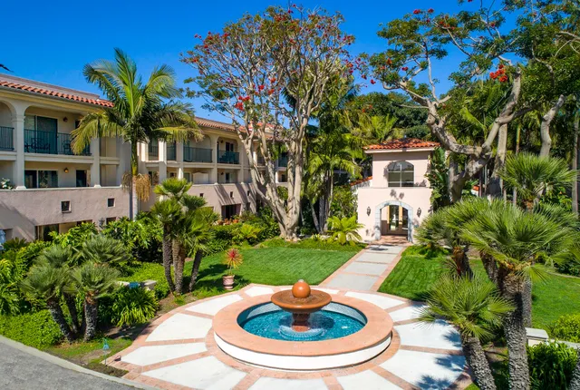 a view of a house with a yard fire pit