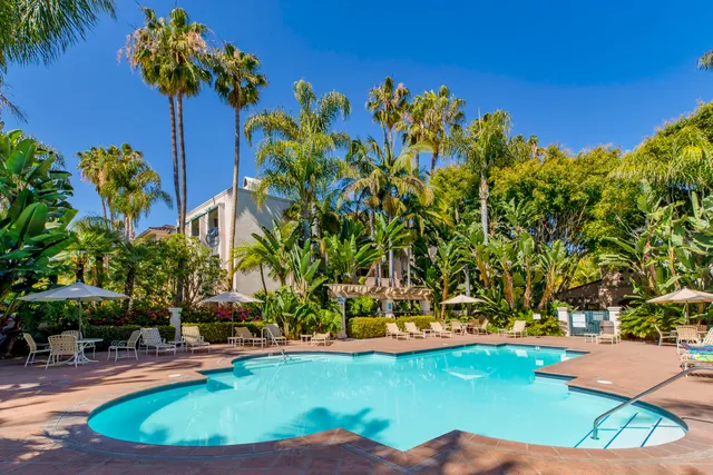 a view of a swimming pool with an outdoor space and seating area