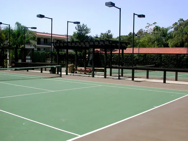 a view of a swimming pool with a bench and trees in the background
