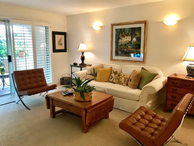 a living room with furniture and a potted plant