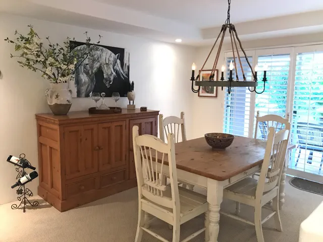a view of a dining room with furniture and a chandelier