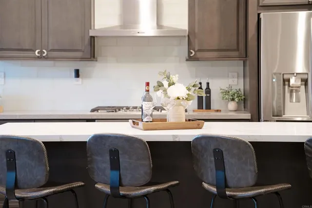 a kitchen with stainless steel appliances a sink dishwasher stove top oven and refrigerator