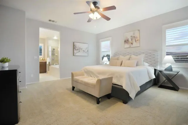 a spacious bathroom with a tub sink and a mirror