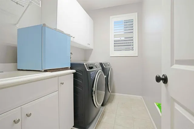 a view of a patio with couches table and chairs under an umbrella