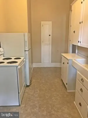 a view of a storage & utility room with cabinets
