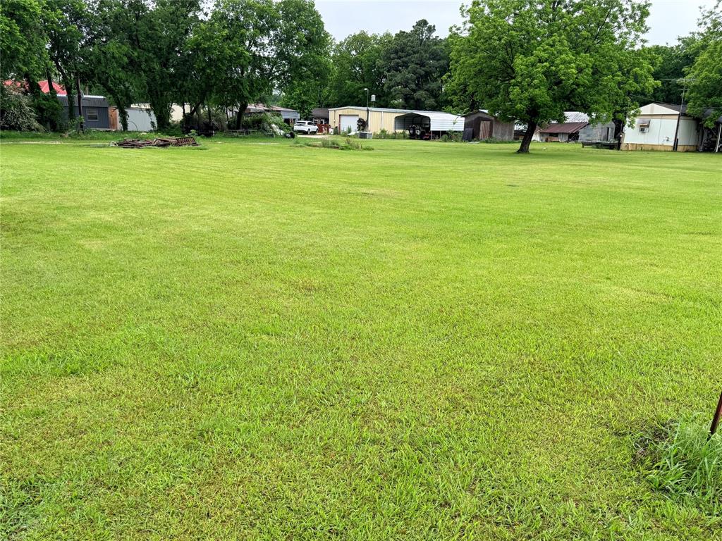 208 South Porch Street Tioga, TX 76271 - Photo 2 of 5 a view of a green field with lawn chairs