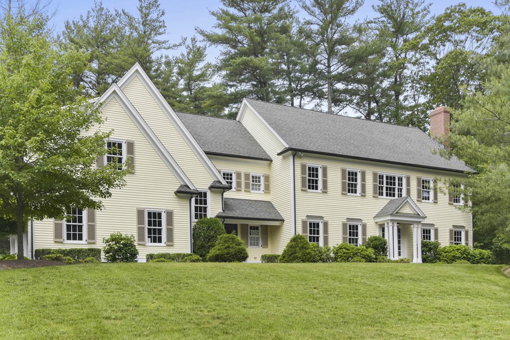 a front view of a house with a garden