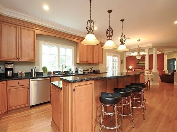 81 Montvale Road Weston, MA 02493 - Photo 13 of 27 a kitchen with stainless steel appliances granite countertop a stove a sink dishwasher a dining table and chairs with wooden floor