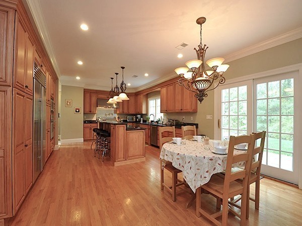 81 Montvale Road Weston, MA 02493 - Photo 14 of 27 a dining room with furniture a chandelier and wooden floor