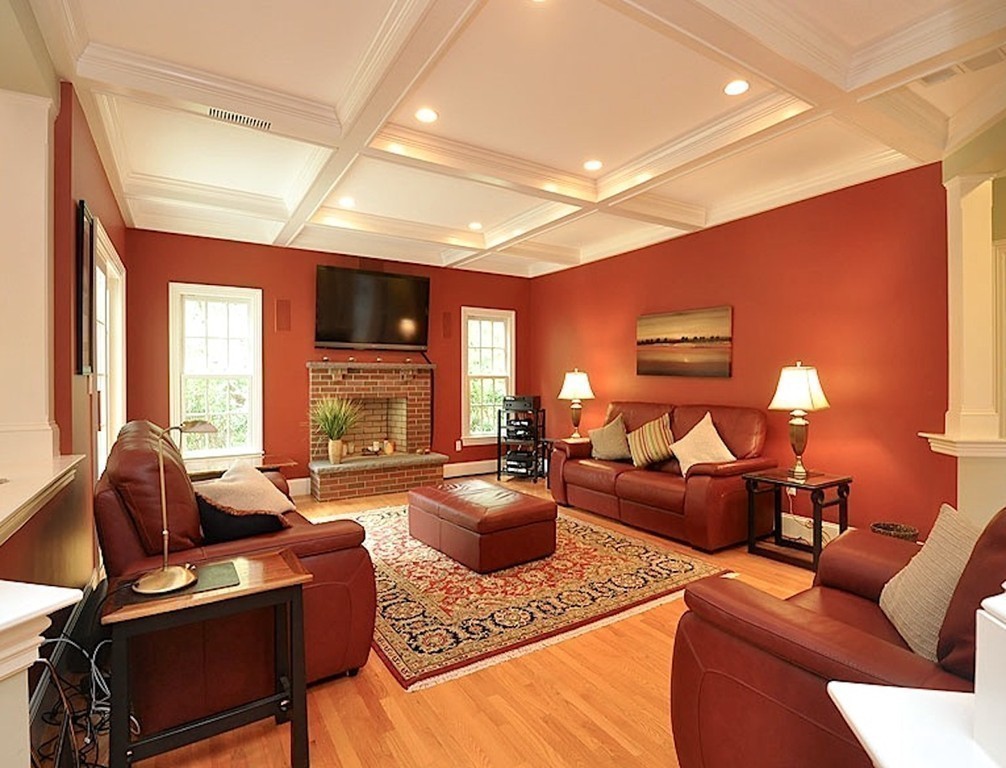 81 Montvale Road Weston, MA 02493 - Photo 17 of 27 a living room with furniture a fireplace and a flat screen tv